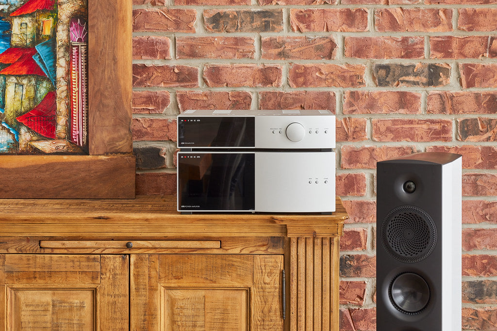 Silver Anthem STR Preamplier and Anthem STR Power Amplifer on Woodenshelf with Paradigm Persona Speaker