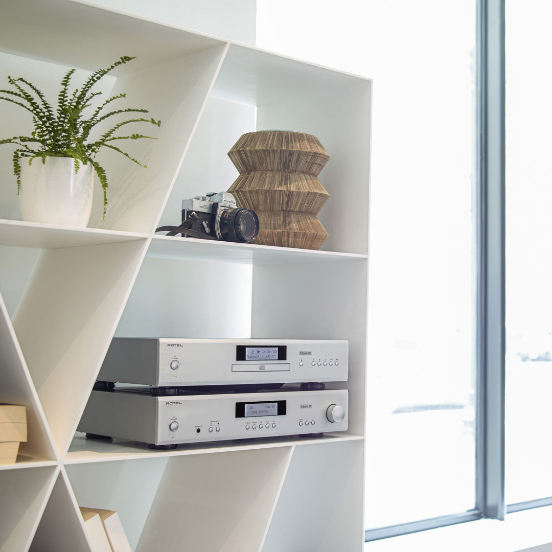 Rotel A11 Tribute Integrated Amplifier in Silver on shelf with Rotel CD player | Holburn Online
