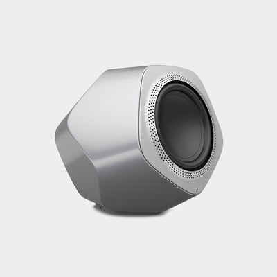 A silver subwoofer designed and manufactured by Bang & Olufsen