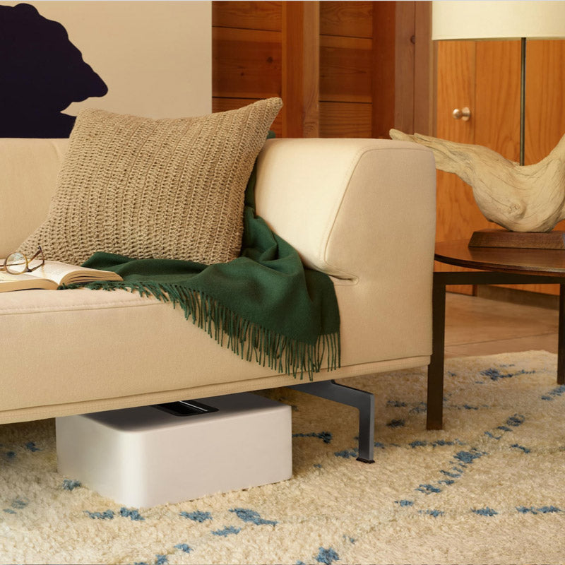 This subwoofer is so flexible in its placement options that it is placed under the sofa in this living rom